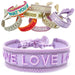 KI-generiertes Bild Canvas Statement Armband Love Lila Flieder Quasten besticktes Webarmband