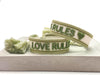 Canvas Statement Armband Love Rules Weiß Grün Quasten besticktes Webarmband